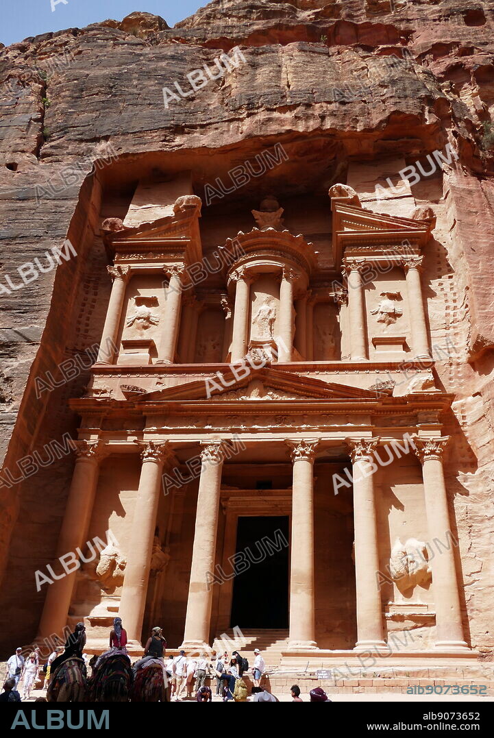 Al-Khazneh (The Treasury) a temple in the ancient Nabatean Kingdom city of Petra, Jordan. The structure was carved out of a sandstone rock face and is believed to have been the mausoleum of the Nabatean King Aretas IV in the 1st century AD. It is one of the most popular tourist attractions in both Jordan and the region. In 1812, the city of Petra and Al-Khazneh was rediscovered by Swiss explorer Johann Ludwig Burckhardt.