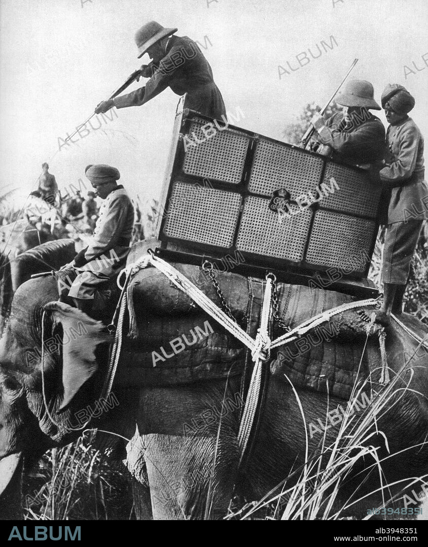 George V shooting tigers, India, 1911, (1935). The King and Queen Mary travelled to India in 1911 to attend the Delhi Durbar, held to commemorate their coronation. A print from King Emperor's Jubilee, 1910-1935, by FGH Salusbury, Daily Express Publications, London, 1935.