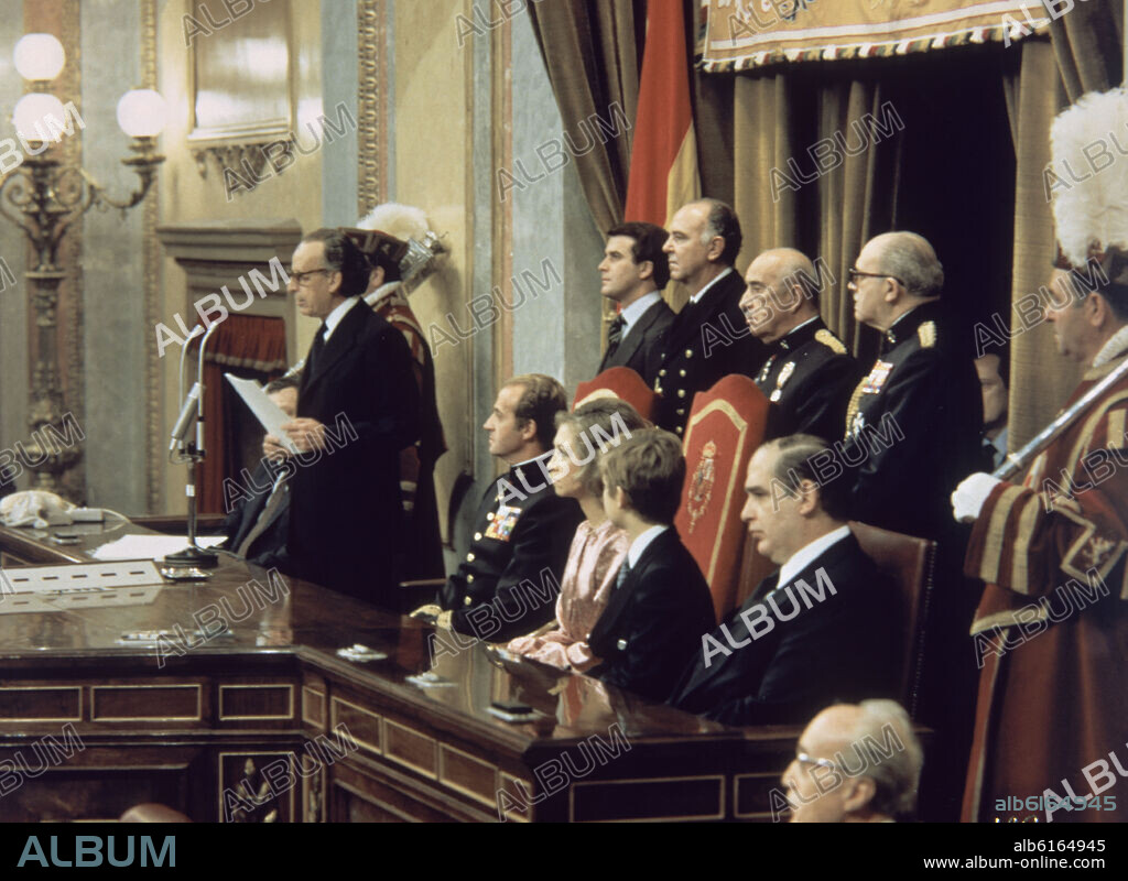 Speech of Hernandez Gil during the Spanish Constitution signature ceremony in 1978. Juan Carlos of Spain and his wife Sophia are seated with their son Felipe. Behind them, the two Parliament Houses' presidents. Madrid, Senate.