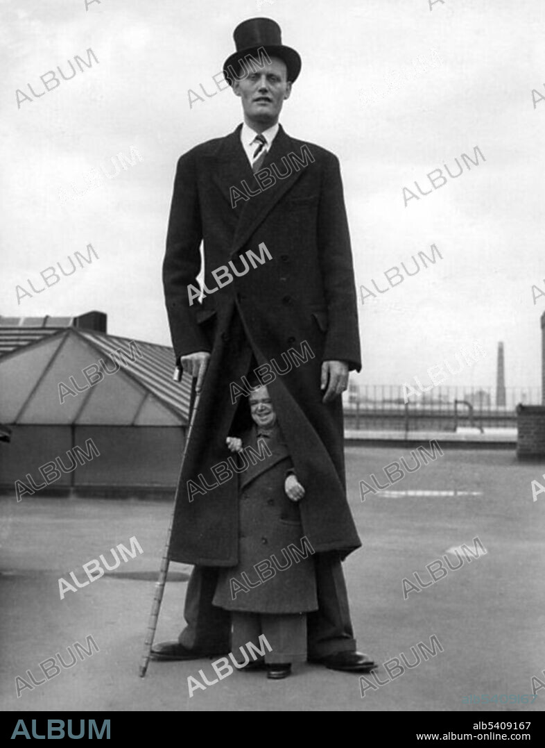 A photograph of Albert Johan Kramer, a giant, with Fred Aslett, a dwarf. Kramer is 8 ft 9 3/4 inches; Aslett is 2ft 4 inches.  Gigantism is a rare disorder resulting from increased levels of growth hormone before the fusion of the growth plate, which usually occurs at some point soon after puberty. This increase is most often due to abnormal tumor growths on the pituitary gland. Dwarfism can result from many medical conditions, each with its own separate symptoms and causes. Extreme shortness in humans with proportional body parts usually has a hormonal cause, such as growth-hormone deficiency, once called pituitary dwarfism. Two disorders, achondroplasia and growth hormone deficiency, are responsible for the majority of human dwarfism cases.