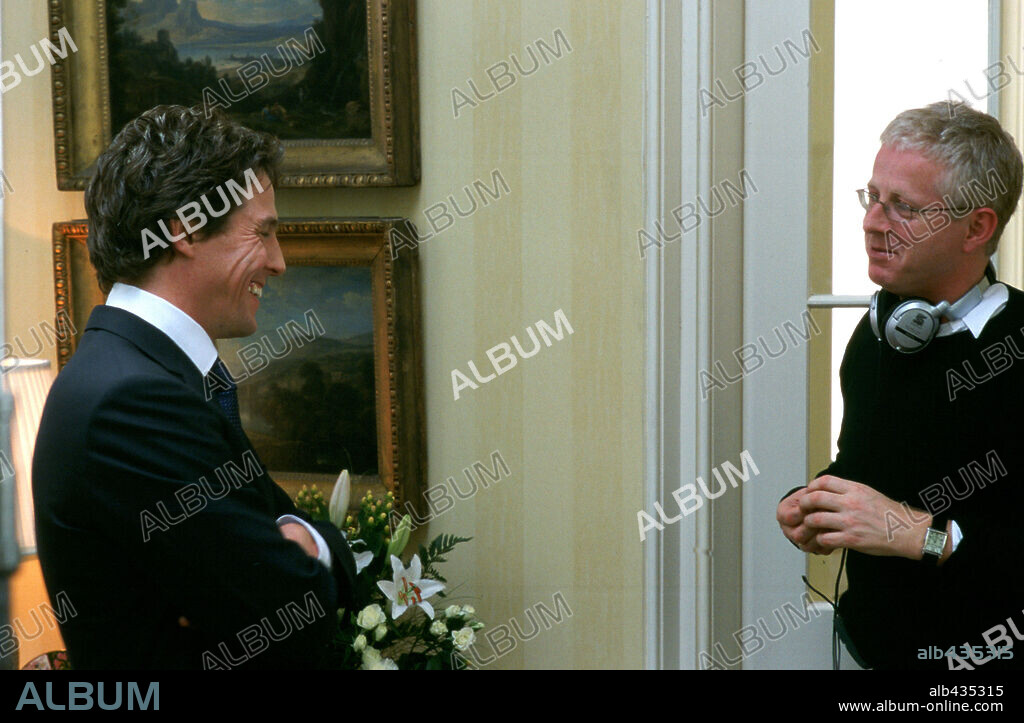 HUGH GRANT and RICHARD CURTIS in LOVE ACTUALLY, 2003, directed by RICHARD CURTIS. Copyright UNIVERSAL STUDIOS / MOUNTAIN, PETER.