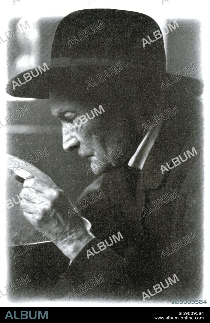 Jean-Henri Fabre (1823-1915) French entomologist examining an insect through a hand lens or magnifying glass.