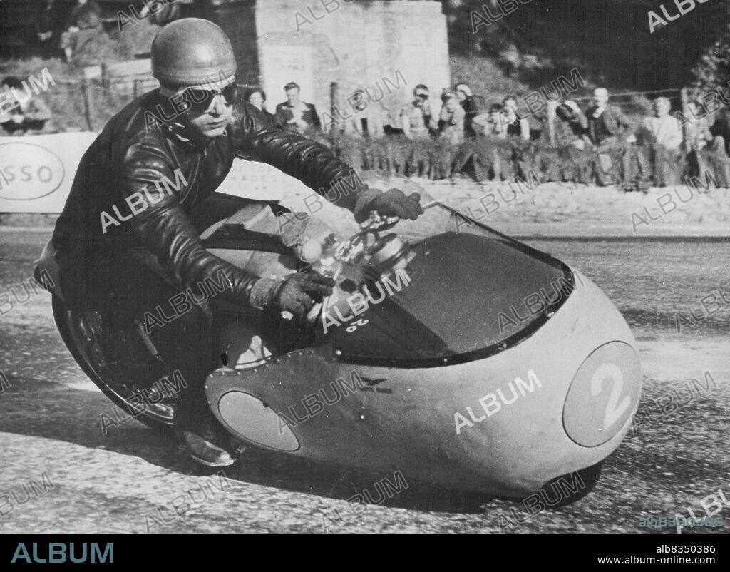 Italian Challenge in T.T. RacesDuillo Acostini, a member of the Italian Guzzi team, at speed on a Junior 350 ***** Guzzi during practice on the T.T. course on the Isle of Man in readlness for next week's races. June 3, 1955. (Photo by Central Press Photos).