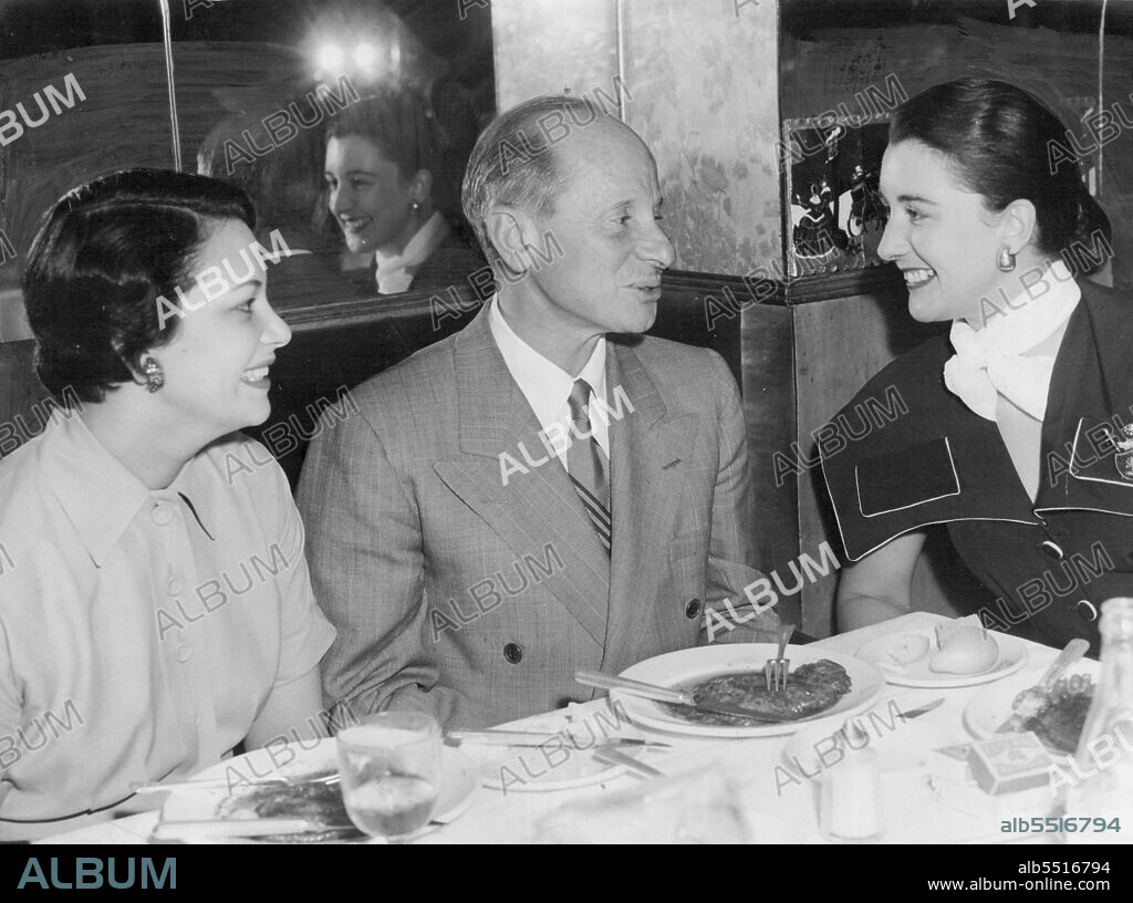 Film-Magnate Arthur Loew entertained Elaine Voges and Melbourne girl Dawn Ingram at Romano's during the week. December 22, 1951.