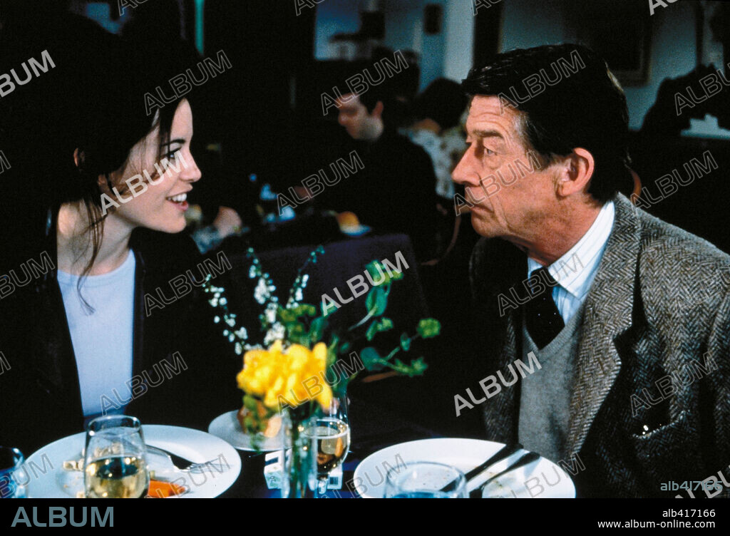 FIONA LOEWI and JOHN HURT in LOVE AND DEATH ON LONG ISLAND, 1997, directed by RICHARD KWIETNIOWSKI. Copyright MIKADO FILMS/BBC/BRITISH SCRREN/SALES CO.