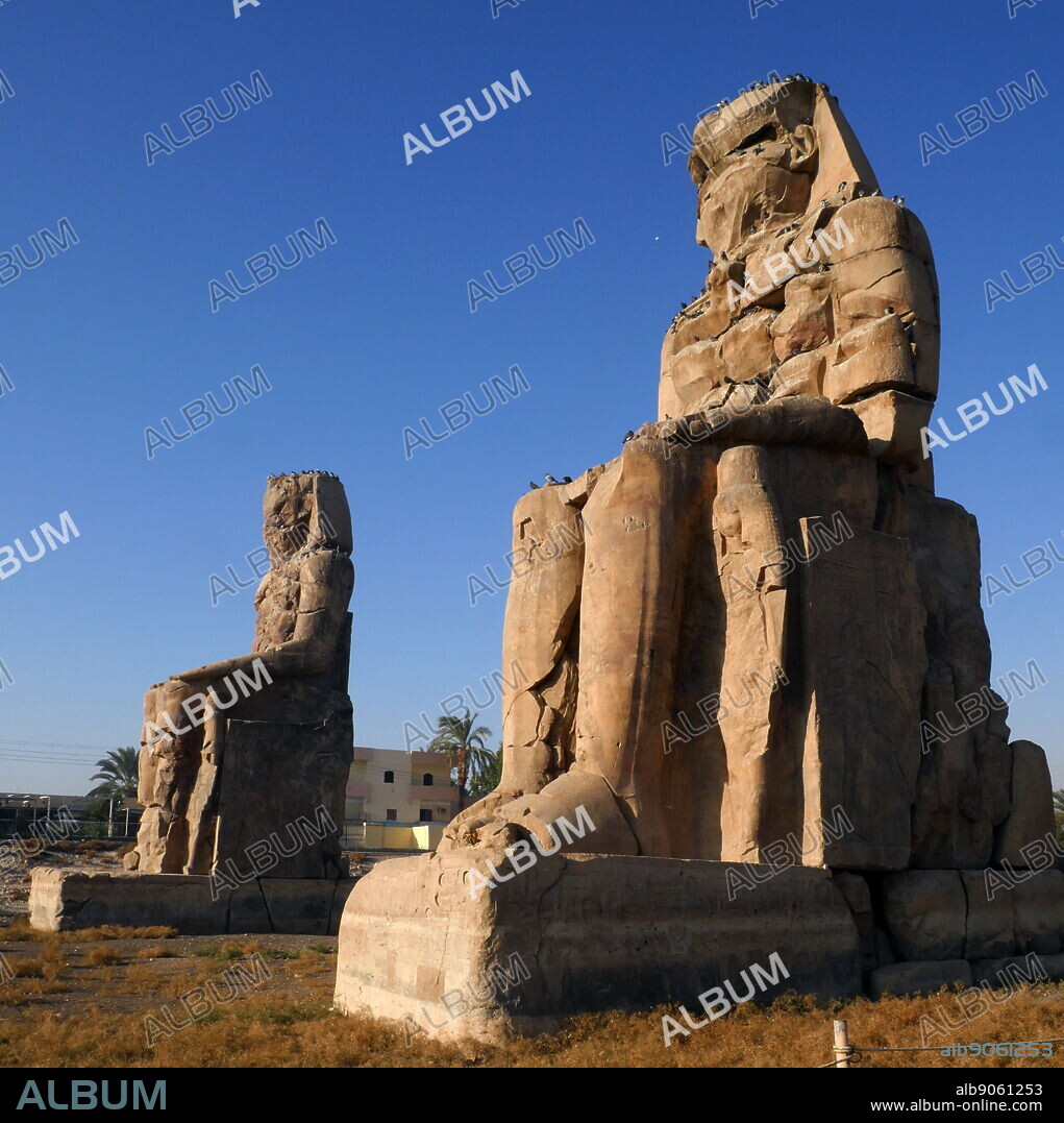 The Colossi of Memnon; are two massive stone statues of the Pharaoh Amenhotep III, who reigned in Egypt during the Dynasty XVIII. Since 1350 BC, they have stood in the Theban Necropolis, located west of the River Nile from the modern city of Luxor. the Mortuary Temple of Amenhotep III, also known as Kom el-Hettân, built by the architect Amenhotep, son of Habu, for the Pharaoh Amenhotep III (or Amenhetep III) during the 18th Dynasty in the New Kingdom.