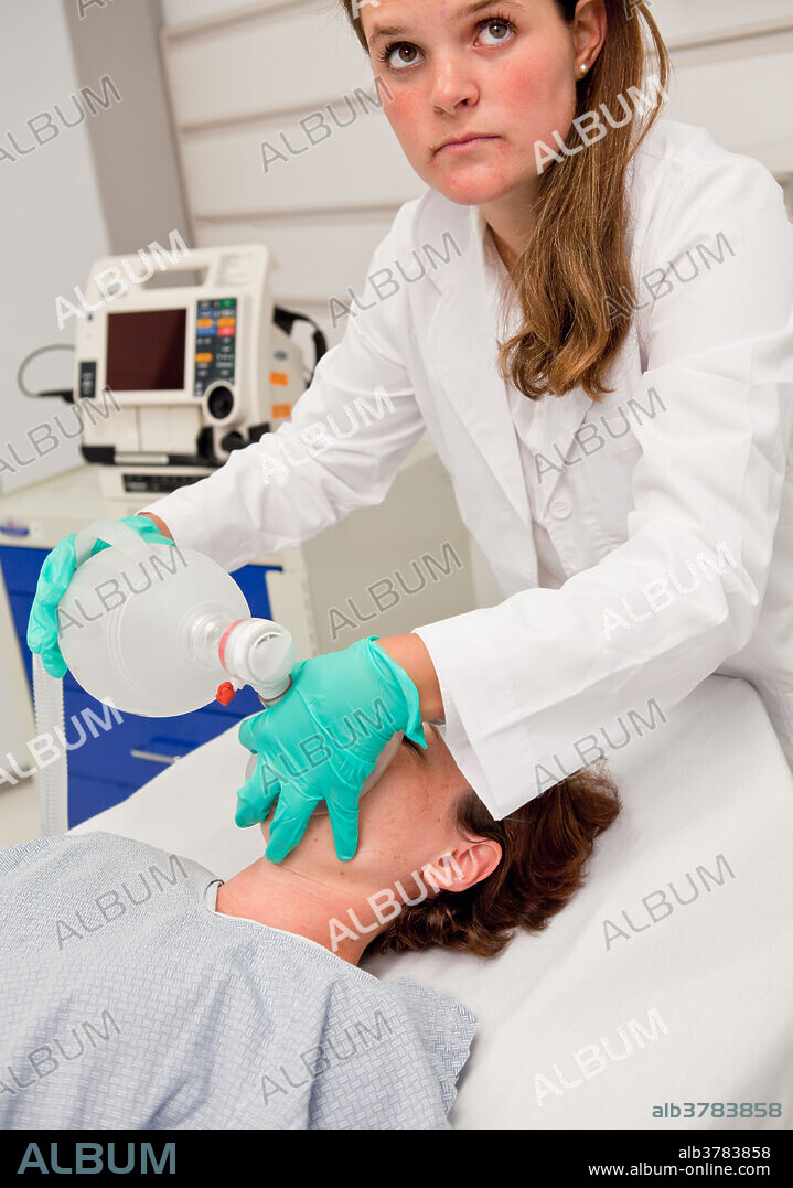 Medical technician employing a bag valve mask, also known as a BVM or Ambu bag, to provide positive pressure ventilation to a patient who is not breathing or who is breathing inadequately.
