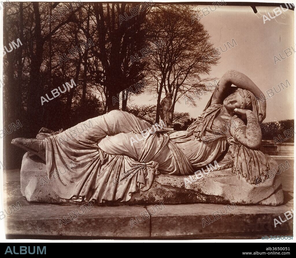 EUGÈNE ATGET. Versailles. Artist: Eugène Atget (French, Libourne 1857-1927 Paris). Dimensions: Image: 17.5 x 21.9 cm (6 7/8 x 8 5/8 in.)
Sheet: 18 × 21.9 cm (7 1/16 × 8 5/8 in.)
Mat: 16 × 20 in. (40.6 × 50.8 cm). Date: 1924-25.
From 1898 until his death in 1927, Atget exhaustively documented the remains of Old Paris: the city's streets, monuments, interiors, and environs. Among the last entries in this self-directed preservationist effort was a series of images of landscapes and sculpture in the parks of Saint-Cloud and Versailles. Here, the photographer records a statue of a sleeping Ariadne, the mythical Cretan princess abandoned by her lover Theseus on the island of Naxos. Atget's simultaneously realistic and otherworldly photographs inspired the Surrealist artist Man Ray, who reproduced four of them in a 1926 issue of the journal La Révolution Surréaliste, thus presenting the elder photographer as a modernist forerunner.