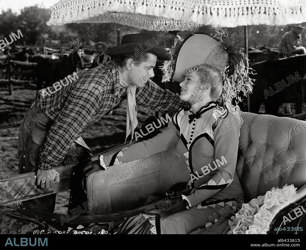 CLAIRE TREVOR and GLENN FORD in THE DESPERADOES, 1943, directed by CHARLES VIDOR. Copyright COLUMBIA PICTURES.