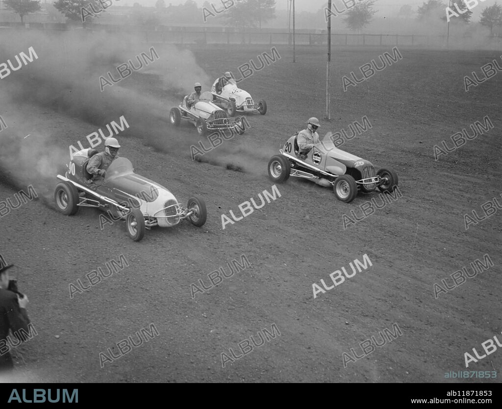 " MIDGETS DEBUT" AT WALTHAMSTOW RACE DRIVERS PRACTISE. Busy warming up for their forthcoming "debut " in London , drivers of the U.S. midget racing cars tried out their "mighty atoms " at Walthamstow stadium today.The cars can touch 80 m.p.h. PICTURE SHOWS:- " Little but good" members of the U.S. midget car team at speed during trials at Walthamstow Stadium today. May 10th 1948.