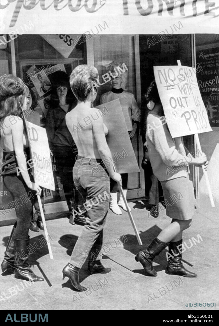 San Francisco, California: March 29, 1966 The amateur topless dancers have muscled in on the pros, and 14 professional dancers are now picketing the Peppermint Tree night club. They were given final notice after last night's show and are being replaced by amateurs. The owner said, 'It's a matter of economics.'.
