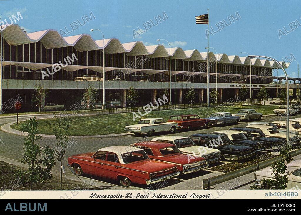 Minneapolis-St Paul International Airport, Minnesota, USA, 1970. Vintage postcard showing the terminal building of the Minneapolis-Saint Paul International Airport. Vintage automobiles are parked in the lot in front of the terminal.