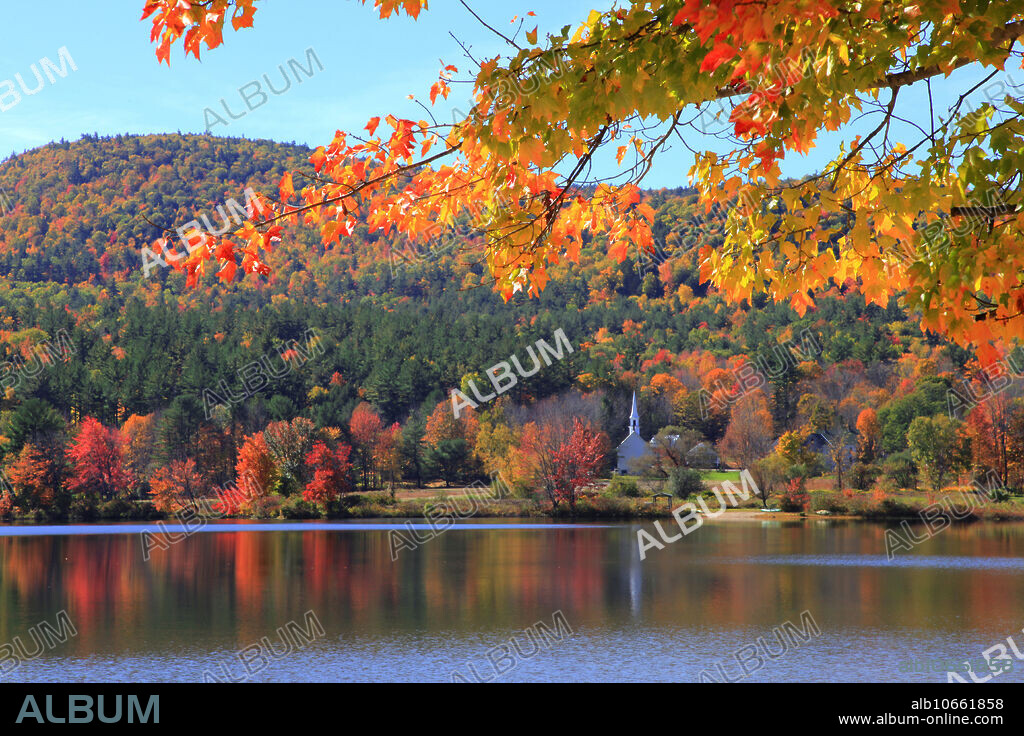 View of Crystal Lake, New Hampshire, in autumn. The Little White Church (built 1879) can be seen in the distance.