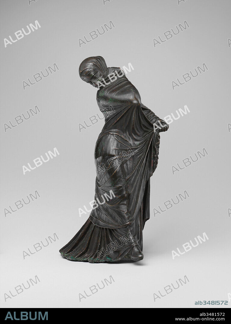 Bronze statuette of a veiled and masked dancer, Hellenistic, 3rd–2nd century B.C., Greek, Bronze, 8 1/16 × 3 1/2 × 4 1/2 in., 65.6oz. (20.5 × 8.9 × 11.4 cm, 4.1 lb.), Bronzes, The complex motion of this dancer is conveyed exclusively through the interaction of the body with several layers of dress. Over an undergarment that falls in deep folds and trails heavily, the figure wears a lightweight mantle, drawn tautly over her head and body by the pressure applied to it by her right arm, left hand, and right leg.