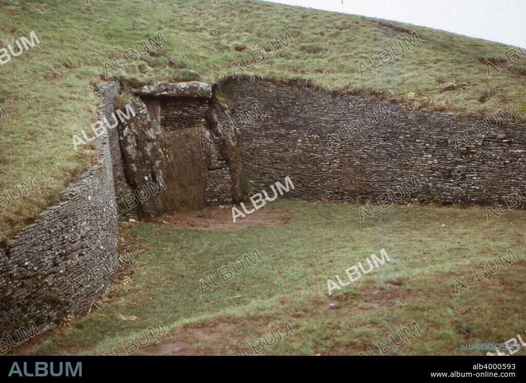 Long Barrow of Belas Knap, near Winchcombe, Gloucestershire, 20th century. A neolithic chambered long barrow, situated on Cleeve Hill in Gloucestershire, England. The False Entrance at the North End has a  well-preserved convex dry stone wall on each side dating from c3500-2500 BC. Used as a burial chamber and collective tomb.