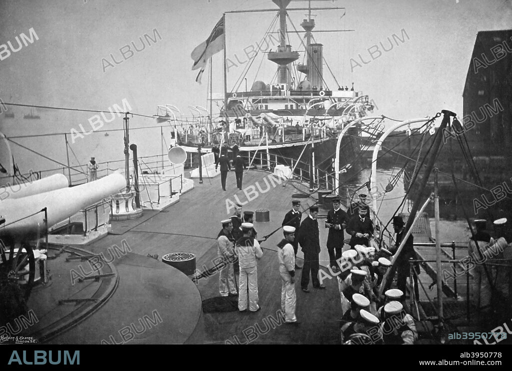 The battleship HMS 'Resolution', Portsmouth, Hampshire, 1896. Just astern is her sister ship 'Royal Sovereign'. The battleships of the 'Royal Sovereign class were the largest warships in the world when they were launched in the early 1890s. A print from The Navy and Army Illustrated, 3rd January 1896.