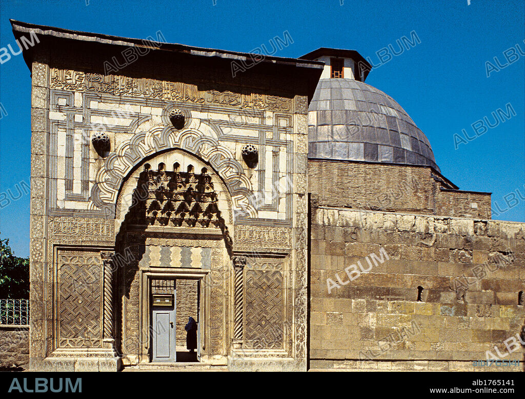 Madrasa or Madrasah or Madrassa Byk Karatay, by Unknown Artist, 1251-1252, 13th Century,. Turkey, Anatolia, Konya, Konya, Byk Karatay MadrasaMadrasahMadrassa. View of the Byk Karatay madrasa madrasah madrassa. The madrasas madrassas built in Seljukian times were relatively small and had one Ivan only. They were either built around a dome covered courtyard or on a large scale with a longitudinal plan. The facade is crowned by a monumental calligraphy bearing the two color alfiz, which was widely used in the Aleppo region. The muqarnas are arranged in parallel lines. 2009 photograph.