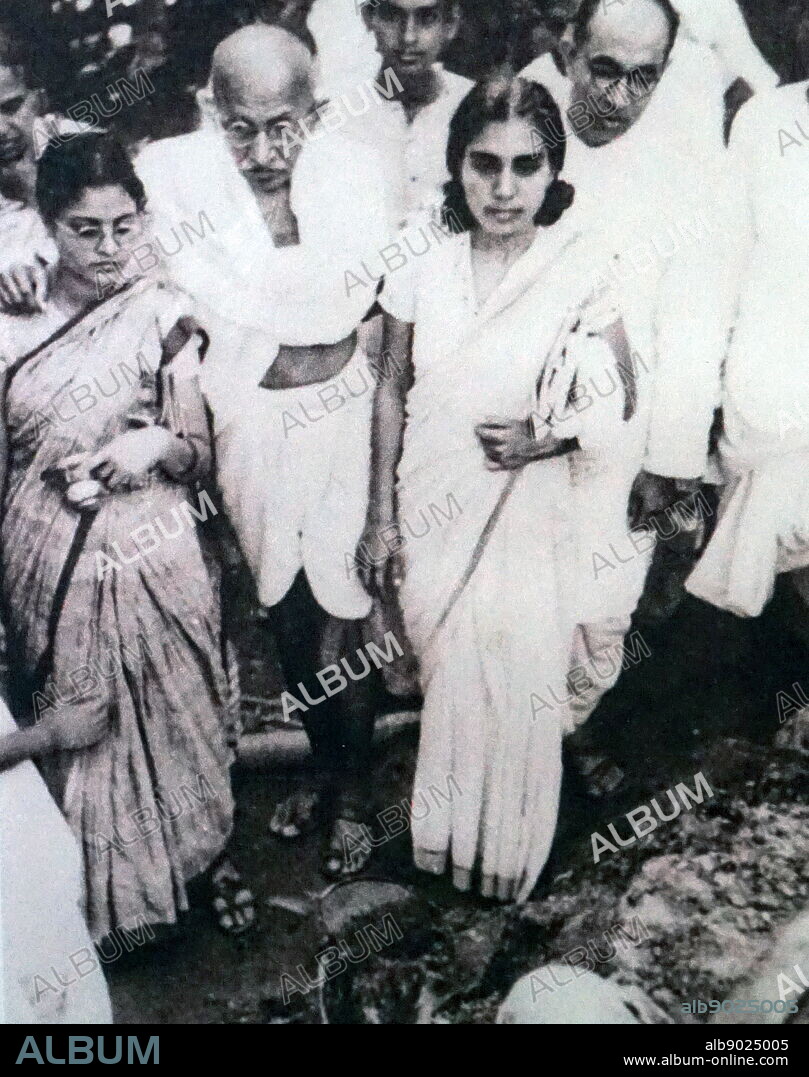 Mahatma Gandhi after a hunger strike is supported by his granddaughter Abha (left) and his doctor Sushila Nayyar. Pyarelal Nayyar his personal secretary stands to the far right.