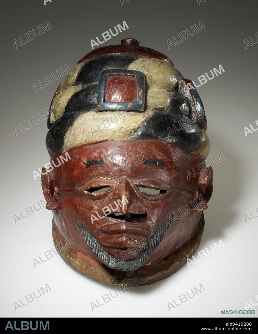 Gelede mask, mid 20th century, 10 1/4 x 12 x 8 3/4 in. (26.04 x 30.48 x 22.23 cm), Wood, pigment, Benin, 20th century, The short beard, pointed nose, and wrapped turban decorated with amulets represent a Muslim cleric. For more than three centuries, Yoruba people have been in contact with Islam and many now practice the faith, occasionally incorporating it into local religious traditions. This mask, for instance, appeared in a performance called Gelede, which celebrates the power of women. The finely carved details and evidence of repainting suggest this was a highly respectedand well-usedmask.