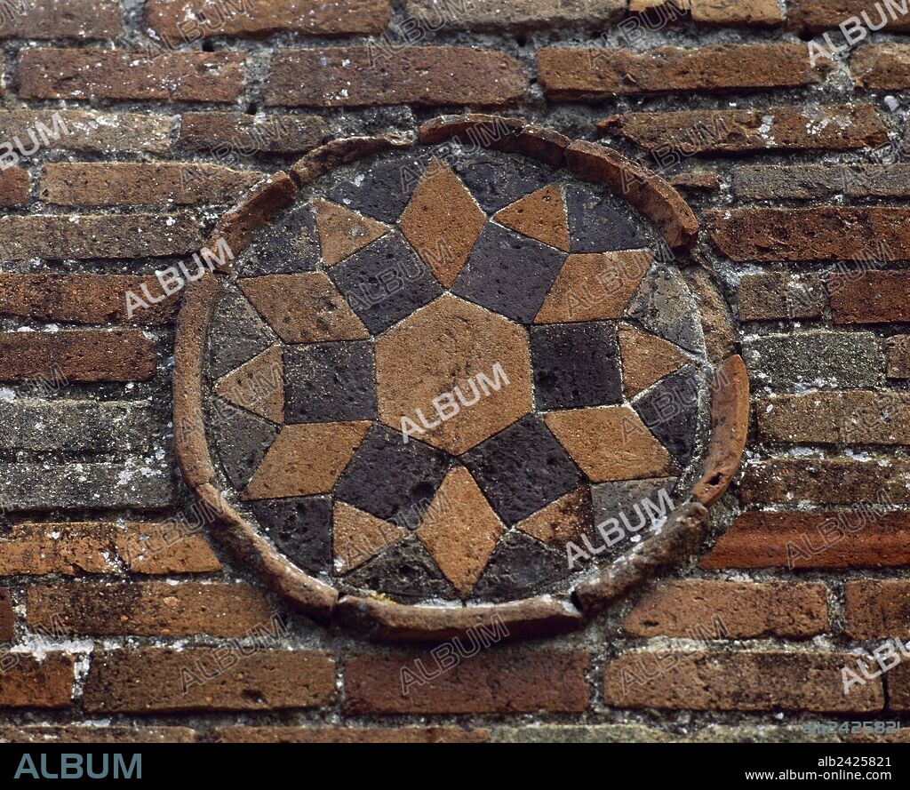 Italy. Pompeii. Medallion. Geometrical decoration, star. Decorative detail , exterior wall of a Roman dwelling. Made in terracotta mosaic. Located at the junction between Street of Abundance and Theatre Street. Campania.
