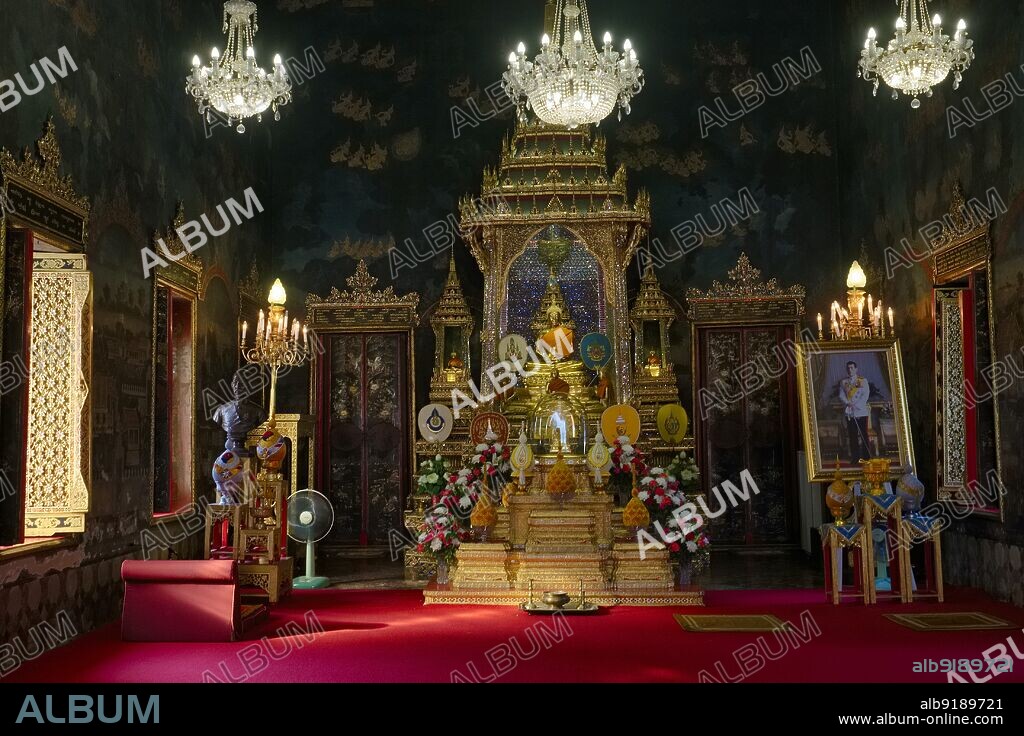 Thailand: A prayer shrine at Wat Ratchapradit in Bangkok, Thailand, a portrait of King Maha Vajiralongkorn (Rama X) on the right. Wat Ratchapradit (Rajapradit) was constructed in the mid-19th century during the reign of King Mongkut (Rama IV). Many of the murals in the main viharn portray Thai ceremonies and festivals that take place during the year and were painted in the late-19th century.