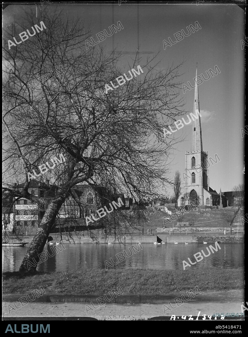 GEORGE BERNARD MASON. St Andrew's Church, Deansway, Worcester, Worcestershire, 1942. St Andrew's Church viewed across the River Severn. The medieval church of St Andrew was demolished in 1948/49 as it was believed to be structurally unstable. Only the church tower, surmounted by a spire, now survives. The tower is also known as Glover's Needle. It is now a Grade II* listed building.