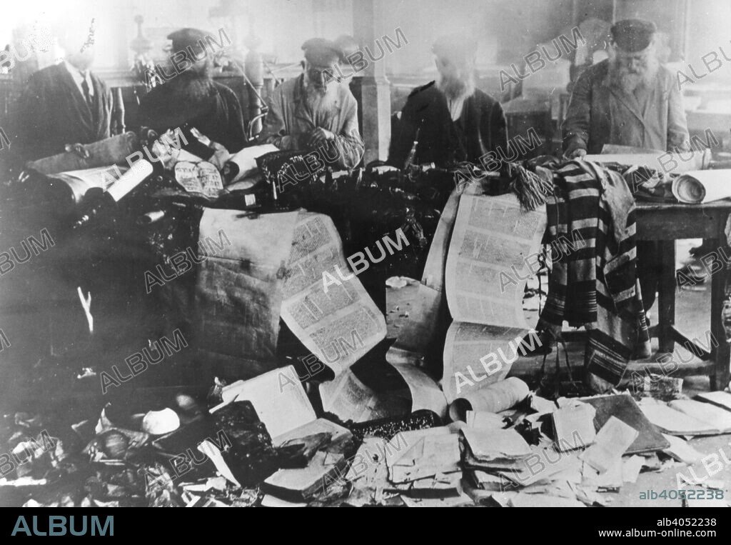 Torah scrolls desecrated during the pogroms, Russia, 1881. Jewish men survey damage done to sacred religious texts.