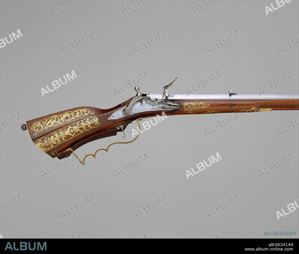 Snaphaunce Hunting Rifle. Culture: Swedish, Stockholm. Dimensions: L. 43 3/8 in. (117.8 cm). Stock maker: Signed by Jonas Schertiger the Younger (Swedish, active 1715-died 1748). Date: dated 1722.
This rifle exemplifies the diverse influences shaping firearms design in eighteenth-century Sweden. Its slender proportions and small-caliber barrel are modeled after the Silesian Tschinke rifle; the prominent cheek stock is typically German, as is the use of inset brass decoration, yet the flat-faced lock copies French models. The lock mechanism, however, is unmistakably Swedish, as the snaphaunce lock was favored in Scandinavia over the wheellock and flintlock commonly used on the Continent. A gunstocker by trade, Jonas Schertiger the Younger was a member of the Stockholm cabinetmakers' guild. His name and the date of manufacture are prominently engraved on the brass inlay on the cheek stock. A blank escutcheon surmounted by a royal crown on the sideplate suggests that this gun was intended for the hunting cabinet of King Frederick I of Sweden (reigned 1720-51).