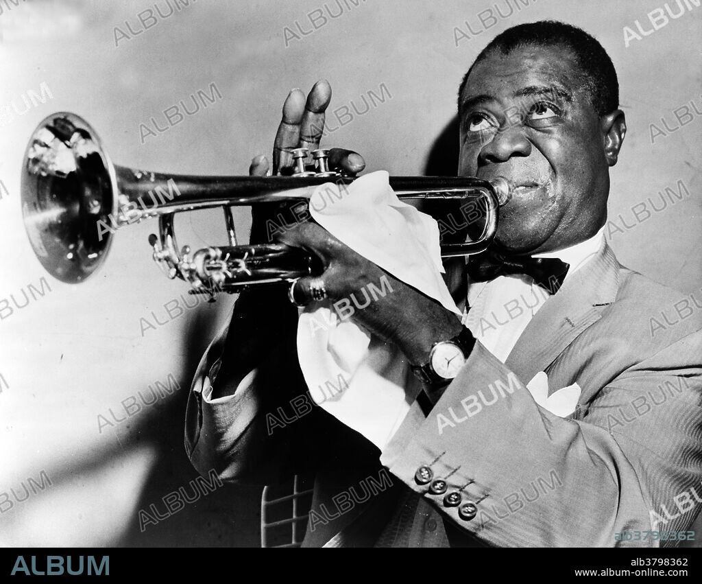 Louis Armstrong (August 4, 1901 - July 6, 1971) was an American jazz trumpeter and singer. One of the most famous musicians of the Harlem Renaissance he was born into a poor New Orleans family. He began to perform with bands in small clubs, and play at funerals and parades around town. In 1922 he was invited to move to Chicago, to play the second cornet in a Creole Jazz Band. Two years later, Armstrong moved to New York City, and began playing his music with the Fletcher Henderson Orchestra at the Roseland Ballroom. In 1929, he made his first appearance on the Broadway stage. In 1942, he married a dancer from the Cotton Club, where his band had performed many times. All throughout the 1950's and 60's, Armstrong appeared in films and made many international tours. He is one of the most appreciated jazz artists of the Harlem Renaissance, and of all times. People learned to appreciate both jazz, and African-American music even more, because of this man. Renowned for his charismatic stage presence and voice almost as much as for his trumpet playing, his influence extended well beyond jazz music. His artistry and personality allowed him socially acceptable access to the upper echelons of American society that were highly restricted for a black man. Armstrong played music up until the day he died at 70 years old, on July 6, 1971. No photographer credited, dated 1953.