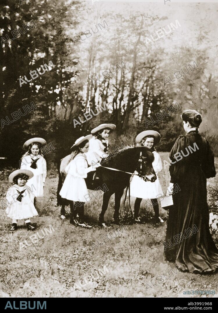 The Russian Imperial family, 1900s. Tsar Nicholas II's (1868-1918) children at play with their pony, watched on by the Tsarina Alexandra (1872-1918). In age order: Grand Duchess Olga Nikolaevna (1895-1918), Grand Duchess Tatiana Nikolaevna (1897-1918), Grand Duchess Maria Nikolaevna (1899-1918), Grand Duchess Anastasia Nikolaevna (1901-1918), and Tsarevich Alexei Nikolaevich (1904-1918).