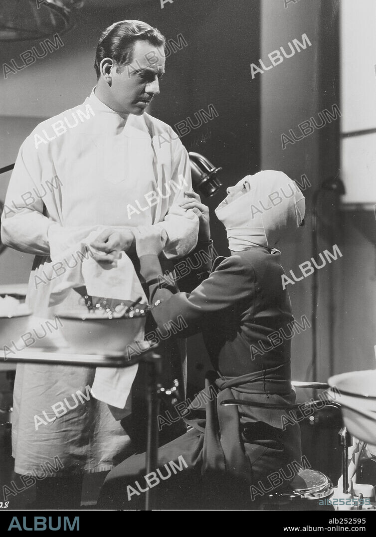 JOAN CRAWFORD and MELVYN DOUGLAS in A WOMAN'S FACE, 1941, directed by GEORGE CUKOR. Copyright M.G.M.