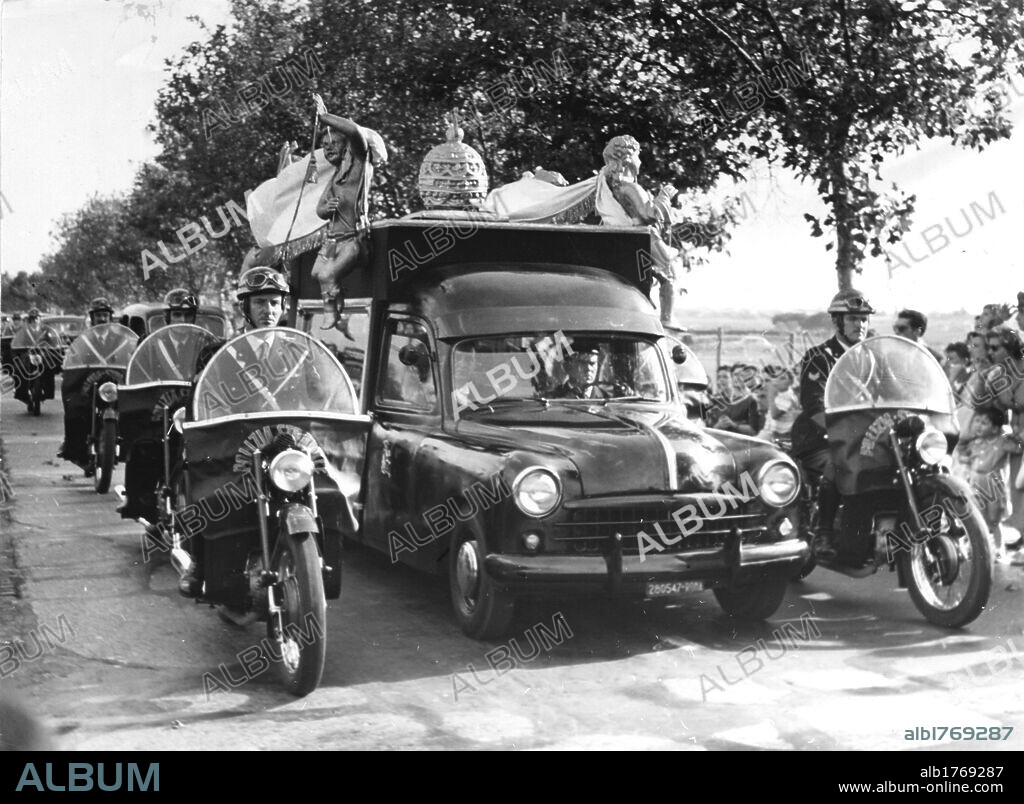 The hearse of the Pope Pius XII. The hearse of the Pope Pius XII going along the Appian Way escorted by motorcycle police. Rome, 10th October 1958.