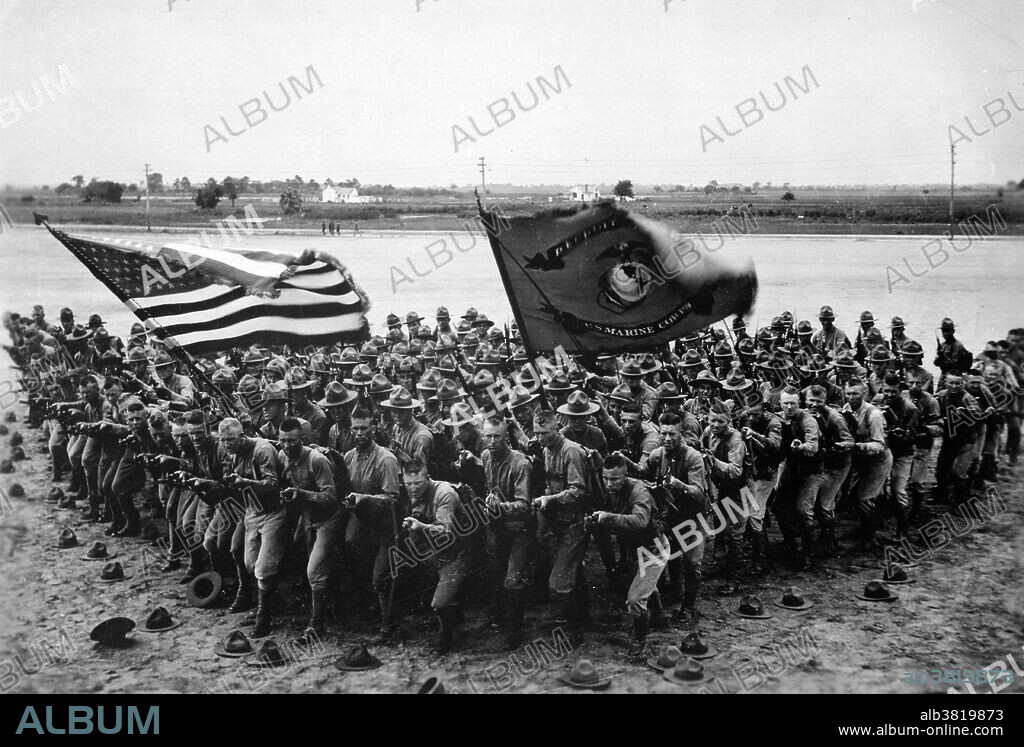 "First to Fight." A group of U.S. Marines. The United States Marine Corps (USMC) is a branch of the United States Armed Forces responsible for providing power projection from the sea, using the mobility of the United States Navy to rapidly deliver combined-arms task forces. During World War I veteran Marines served a central role in the late American entry into the conflict. The Marine Corps had a deep pool of officers and NCOs with battle experience, and experienced a small expansion. The Corps entered the war with 511 officers and 13,214 enlisted personnel, and by 11 November 1918 had reached a strength of 2,400 officers and 70,000 enlisted. Photo taken by U.S. Marine Corps Recruiting Publicity Bureau., 1918.