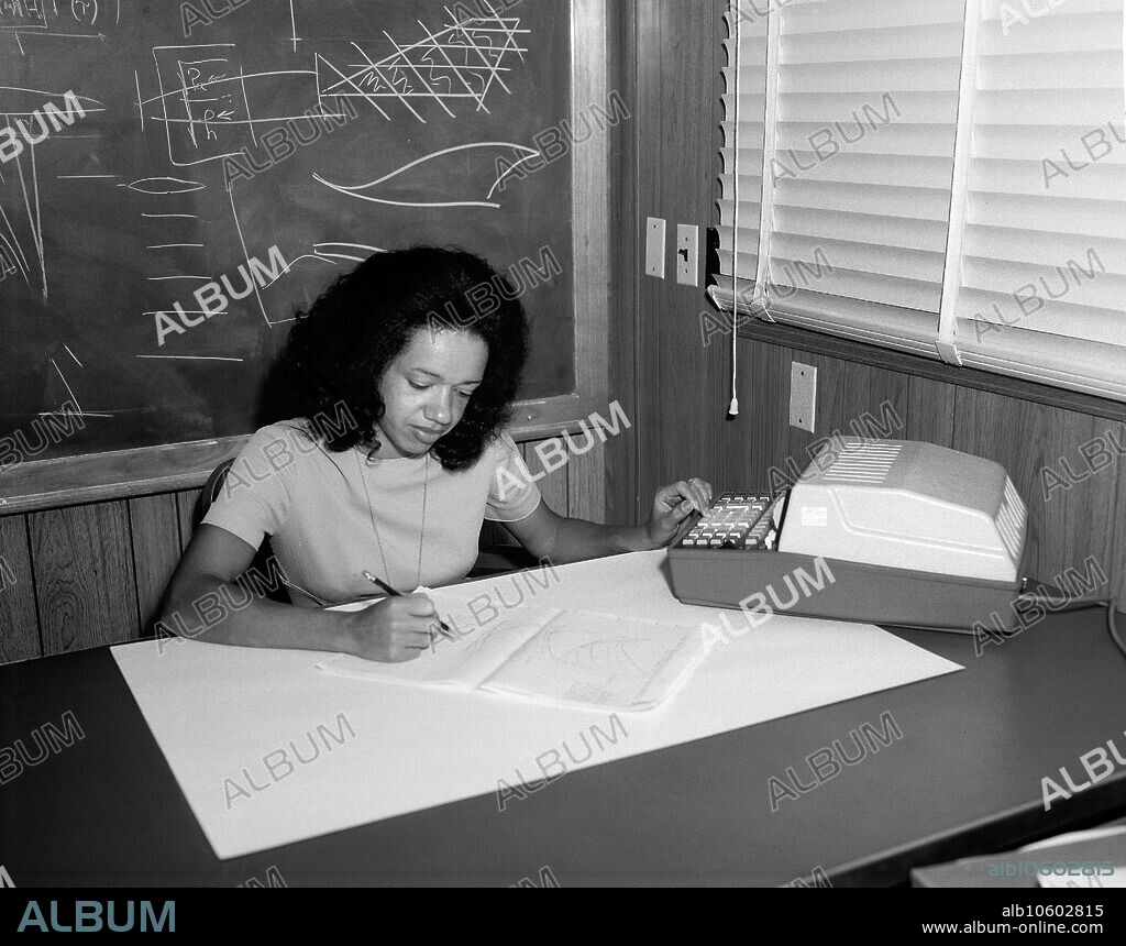 Christine Darden, NASA mathematician, data analyst, and aeronautical engineer, seated portrait working at desk, NASA Langley Research Center, Hampton, Virginia, USA, Bob Nye for NASA, 1973.