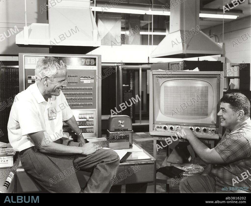 Roger Fulton (at left) and George Michael, project leader, watch the Eyeball project CRT on the IBM 709. The Eyeball, an input device for feeding graphic material directly into a digital computer, was developed by the Theoretical Division at LLNL. The IBM 709 was an early computer system introduced by IBM in 1958. It was an improved version of the IBM 704 and the second member of the IBM 700/7000 series of scientific computers. The improvements included overlapped input/output, indirect addressing, and three "convert" instructions which provided support for decimal arithmetic, leading zero suppression, and several other operations. The 709 had 32,768 words of 36-bit memory and could execute 42,000 add or subtract instructions per second. It could multiply two 36-bit integers at a rate of 5000 per second. An optional hardware emulator executed legacy IBM 704 programs on the IBM 709. This was the first commercially available emulator prior to 1960. IBM introduced a transistorized version of the 709, called the IBM 7090, in November 1959. The FORTRAN Assembly Program was first introduced for the 709. No photographer credited, dated 1961.