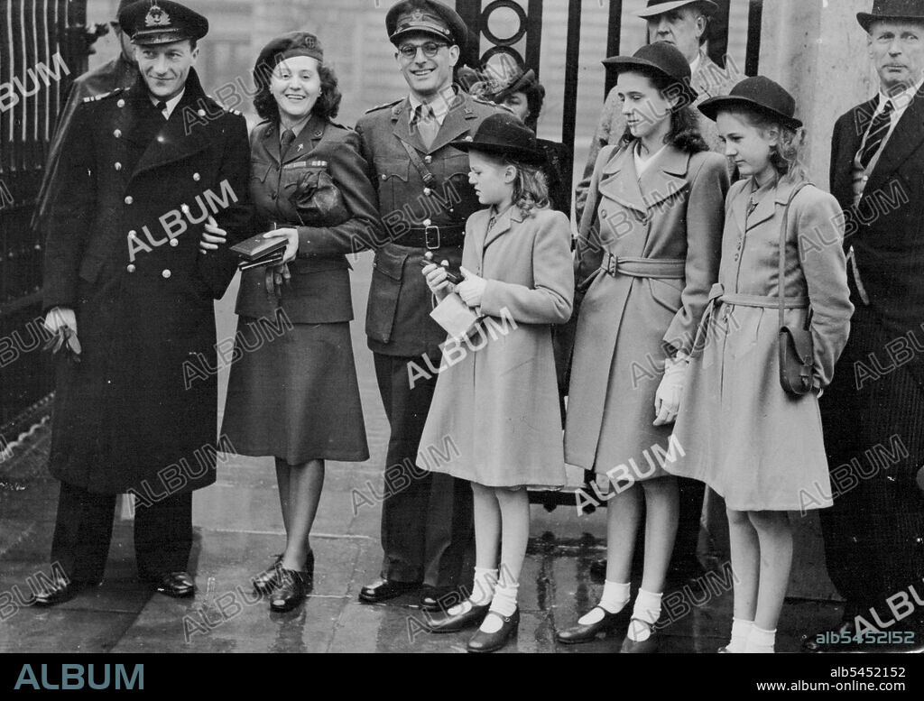 Lise Meets The King -- Outside Buckingham Palace after receiving the George Cross is Mrs. Odette Sansom, on her left is Capt. Peter Churchill, who received the D.S.C., he is the man she never betrayed, and is now to marry, and on her right is Lt. ***** Patrick O'Leary, who received the George cross, his real name is Dr. Albert Guerisse). Mrs. Sansom's three daughters are in the picture, L. to R. Marianne, Francoise and Lilly.Mrs. Odette Sansom, known as Lise in the French underground, was to-day awarded the George Cross for her work in the underground movement - she is the first and only woman to be awarded the George Cross. November 19, 1946.