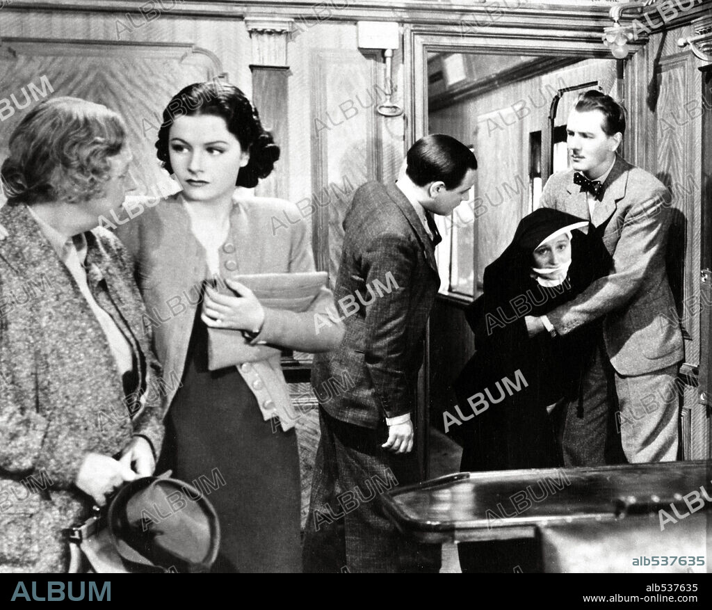 DAME MAY WHITTY, MARGARET LOCKWOOD and MICHAEL REDGRAVE in THE LADY VANISHES, 1938, directed by ALFRED HITCHCOCK. Copyright GAINSBOROUGH FILMS.