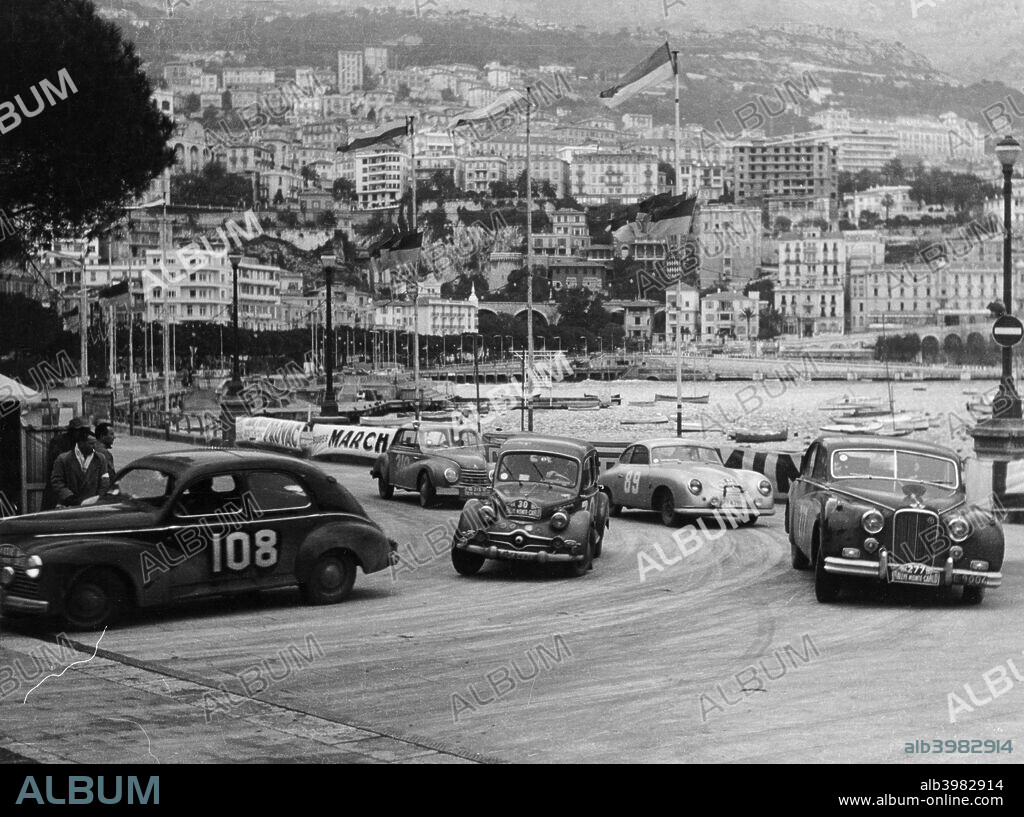 The Monte Carlo Rally, Monaco, 1954. The cars race along the sea front. They are: No 108, a 1290cc contemporary Peugeot 203; No 30, a c1952 850cc Packard Dynn 120; No 277, a 1954 Mk VII Jaguar, 3442cc; No 89, a 1953 Porsche 356; No 317, a 1953 DKW Sonderklasse 3/6, 896cc.