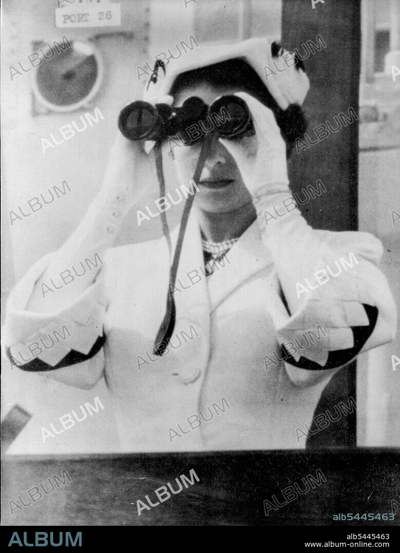 The Queen Reviews The Fleet -- Through binoculars, her Majesty Queen Elizabeth reviews the ships of the Royal Navy and Foreign Navies taking part in the Spithead Naval Review today June 15th. She is pictured on the bridge of the Royal yacht "Surprise". June 15, 1953. (Photo by Associated Press Photo).