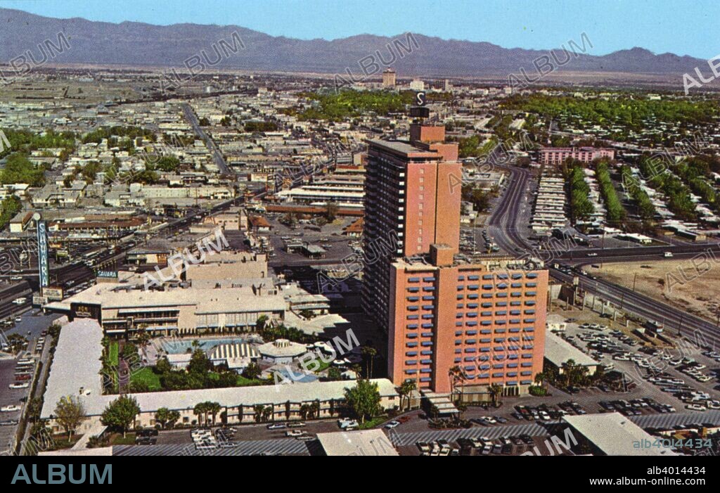 The Sahara Hotel, Las Vegas, Nevada, USA, 1967. Vintage postcard showing a bird's eye view of the Sahara Hotel, the Las Vegas Strip, and the outlying area. The Casino Center is shown in the background and mountains are seen in the distance. The sixth hotel and casino to be built on The Strip, the Sahara opened in 1952.