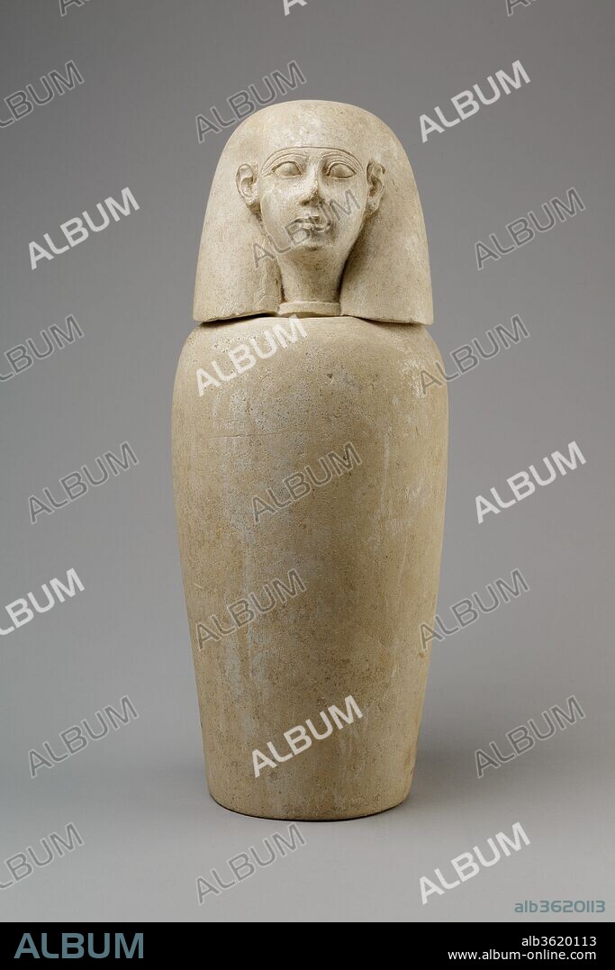 Canopic jar with human head (Imsety). Dimensions: Jar: H. 25.4 cm (10 in.); d. 15.3 cm (6 in.); diam. of base 10.5 cm (4 1/8 in.); diam. of mouth 8 cm (3 1/8 in.); circ. 45.2 cm (17 3/16 in.); Lid: 13 cm (5 1/8 in.); w. 12.5 cm (4 15/16 in.); d. 12.2 cm (4 13/16 in.); diam. of foot 6.5 cm (2 9/16 in.); Jar with Lid: H. 36.3 cm (14 5/16 in.); diam. 14.6 cm (5 3/4 in.). Date: ca. 800-650 BC.
This canopic is part of a set (13.180.1--.4) found in a Ptolemaic cemetery at Thebes. Use of canopics had gone out of fashion at that period, however, so these are certainly reused. Their style suggests they were originally created in the late Third Intermediate Period.
