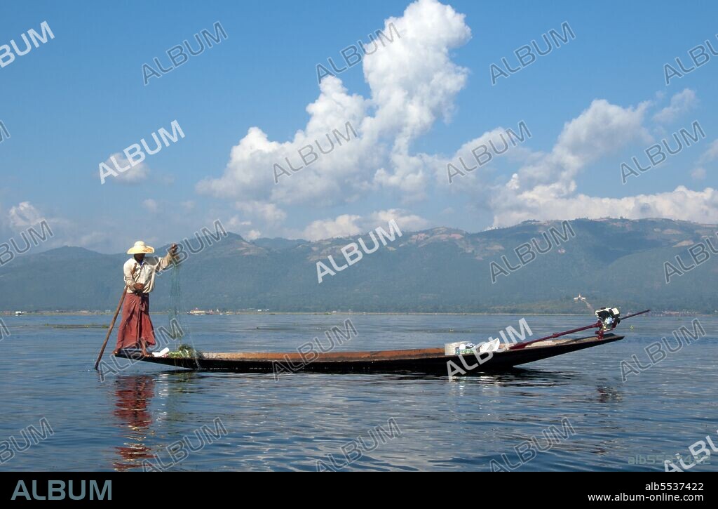 Inle Lake is a freshwater lake located in the Nyaungshwe Township of Taunggyi District of Shan State, part of Shan Hills in Myanmar (Burma). It is the second largest lake in Myanmar with an estimated surface area of 44.9 square miles (116 km2), and one of the highest at an altitude of 2,900 feet (880 m). The people of Inle Lake (called Intha), some 70,000 of them, live in four cities bordering the lake, in numerous small villages along the lake's shores, and on the lake itself. The entire lake area is in Nyaung Shwe township. The population consists predominantly of Intha, with a mix of other Shan, Taungyo, Pa-O (Taungthu), Danu, Kayah, Danaw and Bamar ethnicities. Most are devout Buddhists, and live in simple houses of wood and woven bamboo on stilts; they are largely self-sufficient farmers. Most transportation on the lake is traditionally by small boats, or by somewhat larger boats fitted with single cylinder inboard diesel engines. Local fishermen are known for practicing a distinctive rowing style which involves standing at the stern on one leg and wrapping the other leg around the oar. This unique style evolved for the reason that the lake is covered by reeds and floating plants making it difficult to see above them while sitting. Standing provides the rower with a view beyond the reeds. However, the leg rowing style is only practiced by the men. Women row in the customary style, using the oar with their hands, sitting cross legged at the stern. The Inle lake area is renowned for its weaving industry. The Shan-bags, used daily by many Burmese as a tote-bag, are produced in large quantities here. Silk-weaving is another very important industry, producing high-quality hand-woven silk fabrics of distinctive design called Inle longyi. A unique fabric from the lotus plant fibers is produced only at Inle lake and is used for weaving special robes for Buddha images called kya thingahn or 'lotus robe'.