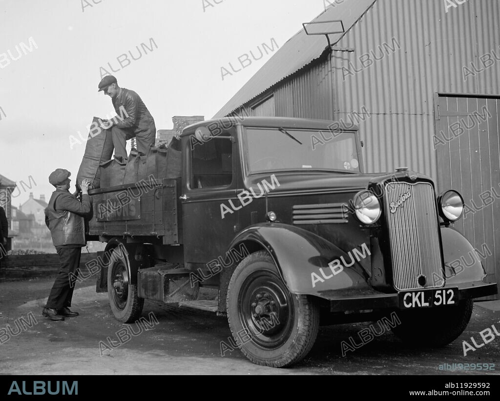 One of the delivery lorries from H Salmon , Coal and Coke Merchants , in Orpington , Kent being loaded with sacks of coal . 1936 .