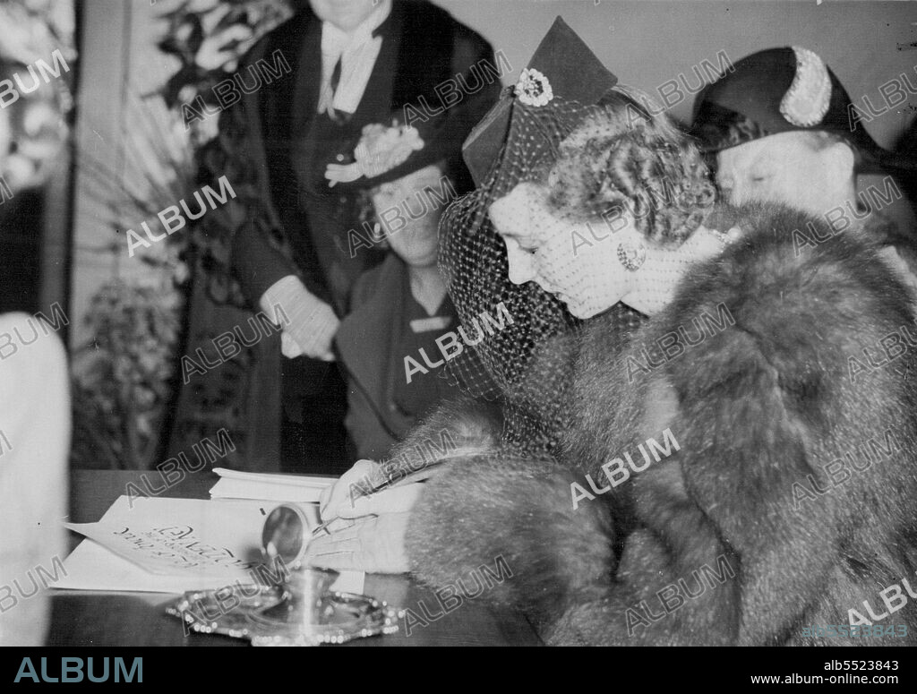Duchess of Kent At Hammersmith Town Hall -- The Duchess of Kent signing the role of honour when at Hammersmith Town Hall for this afternoon's reception.After opening the new buildings of the society for the provision of occupational industries for the physically handicapped, in Uxbridge road this afternoon, March 29, the Duchess of Kent attended a reception in the Hammersmith Town Hall, being entertained  by the mayor. March 29, 1939. (Photo by The Associated Press).