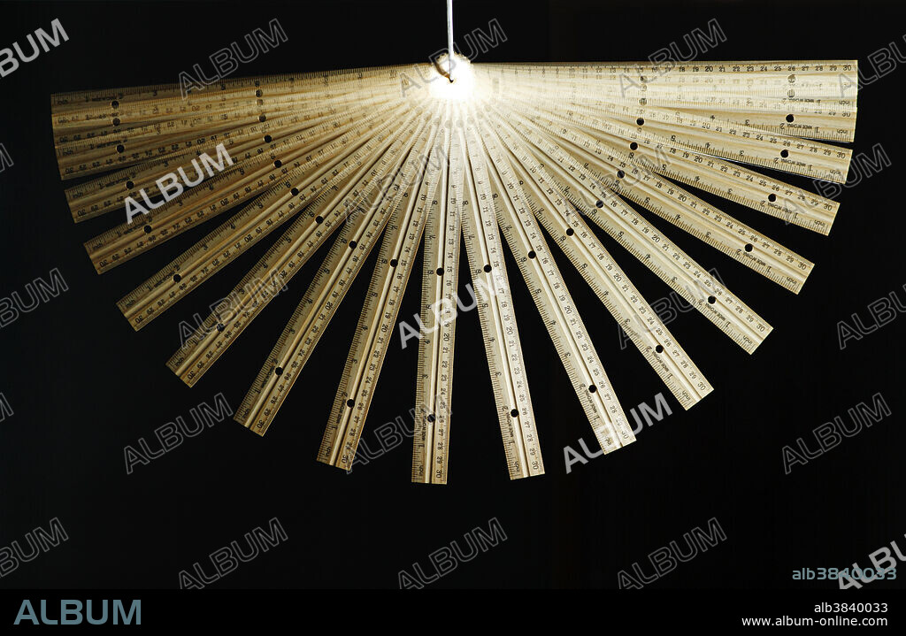 A demonstration of physical pendulum using a wooden ruler. The swing of the pendulum starts on the right. At the end of the swing (on the left) the pendulum does not come up as high. This is because some energy is lost due to friction. Stroboscopic image acquired using a flash operating at 40 Hz.