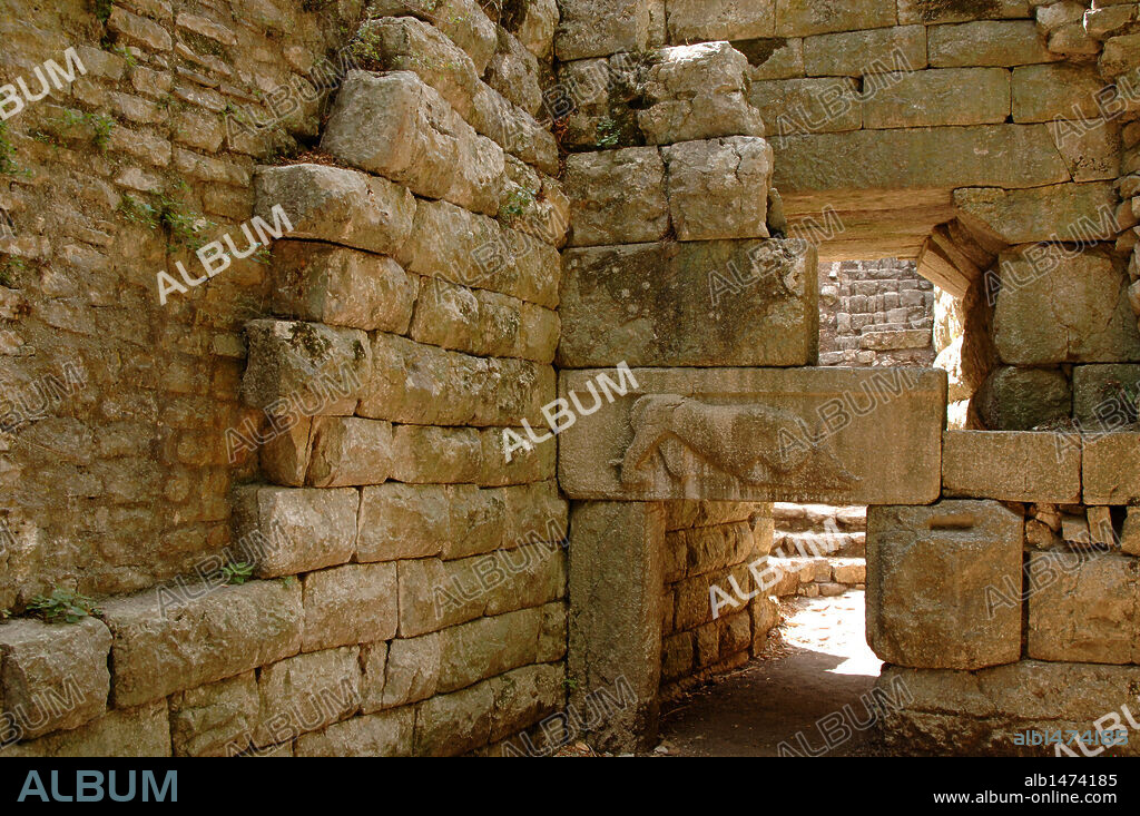 Cyclopean walls of the ancient city dating from IV century B.C. View of the gateway called Lion's Gate, one of the six entrances to the city. It shows a lion devouring a bull. Butrint. Republic of Albania.