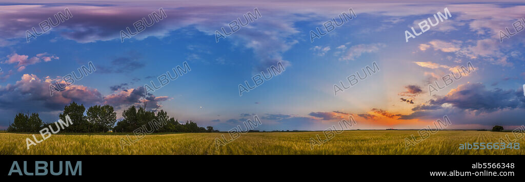 August 6, 2014 - The colors of the sunset sky in a 360 degree panorama at sunset in Alberta, Canada. The setting Sun is at far right, the waxing gibbous moon left of centre.