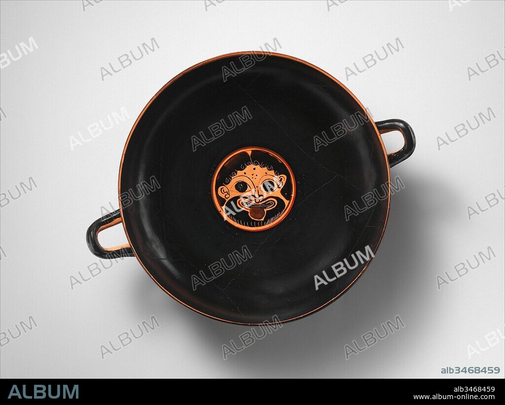 Terracotta kylix: eye-cup (drinking cup), Archaic, ca. 520 B.C., Greek, Attic, Terracotta; black-figure, H. 3 3/4 in. (9.5 cm), Vases, Interior, gorgoneion (Gorgon's face), Exterior, obverse and reverse, between eyes, warrior. This is one of a few Attic cups with a so-called Chalcidizing foot that is characteristic of black-figure cups made by Greek potters in southern Italy.