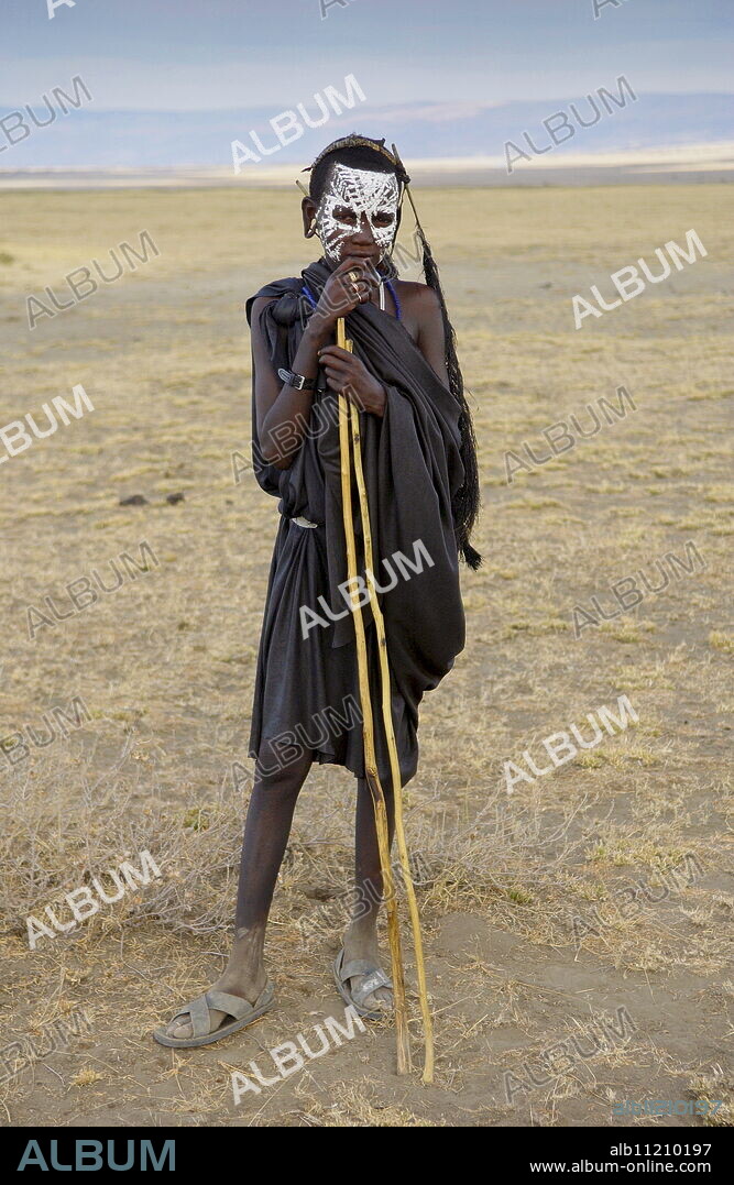 Young recently circumcised Masai Warrior (moran) with traditional face paint after 'coming of age' in the Serengei Plains, Tanzania.