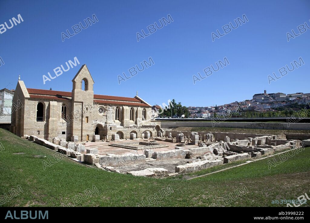 The Monastery of Santa Clara-a-Velha, Coimbra, Portugal, 2009. View of the ruined cloisters and South façade of the church with rose window and bell tower. The monastery was built in the 14th century on the left bank of the Mondego river, but had to be abandoned in the 17th century due to frequent floods. The well-preserved Gothic ruins of the monastery were excavated in the late 20th century, more than 300 years after being abandoned by the nuns.